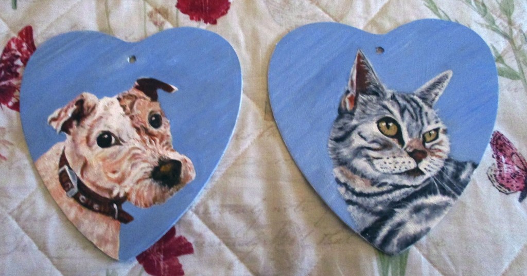 Pair of heart shaped oil pet portraits on wood.